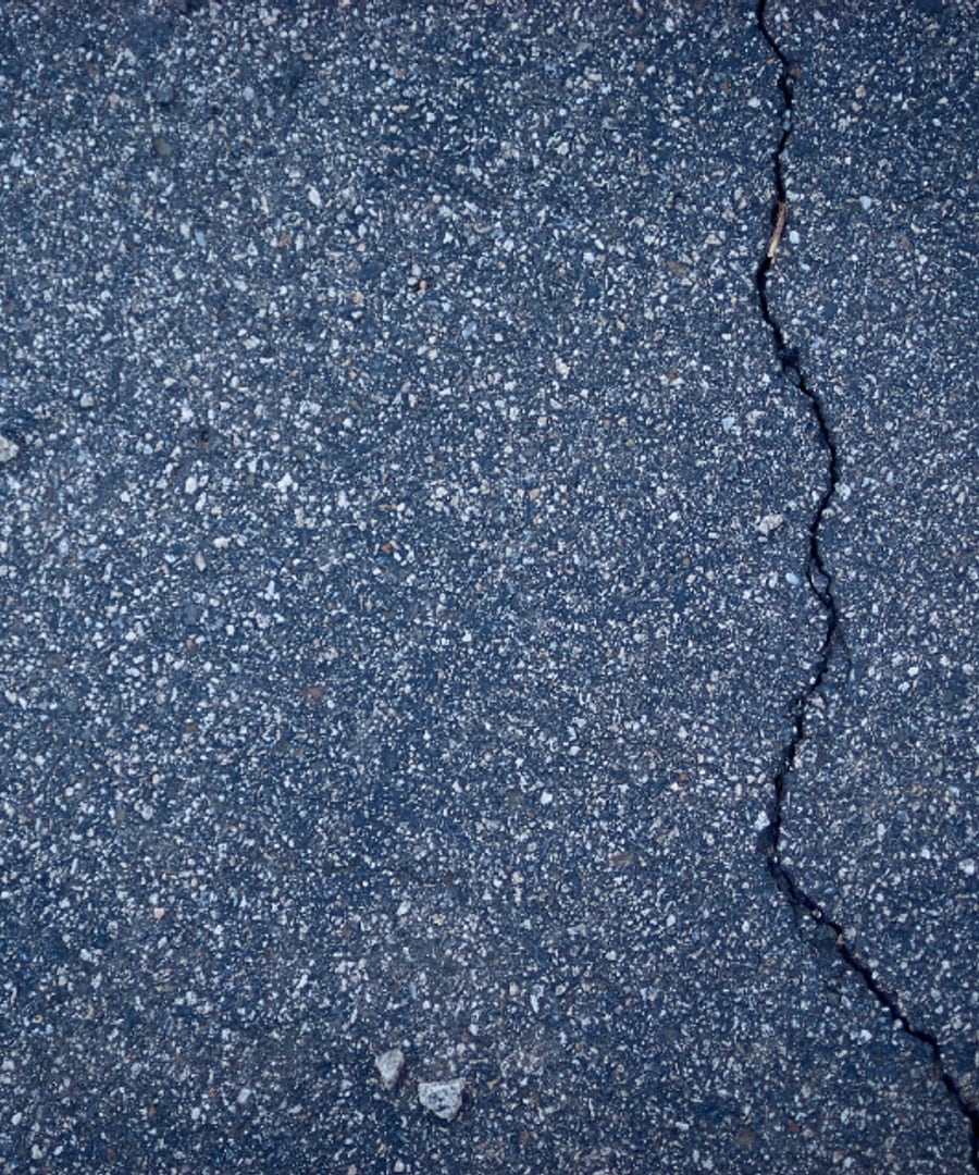 Before, cracked and faded asphalt