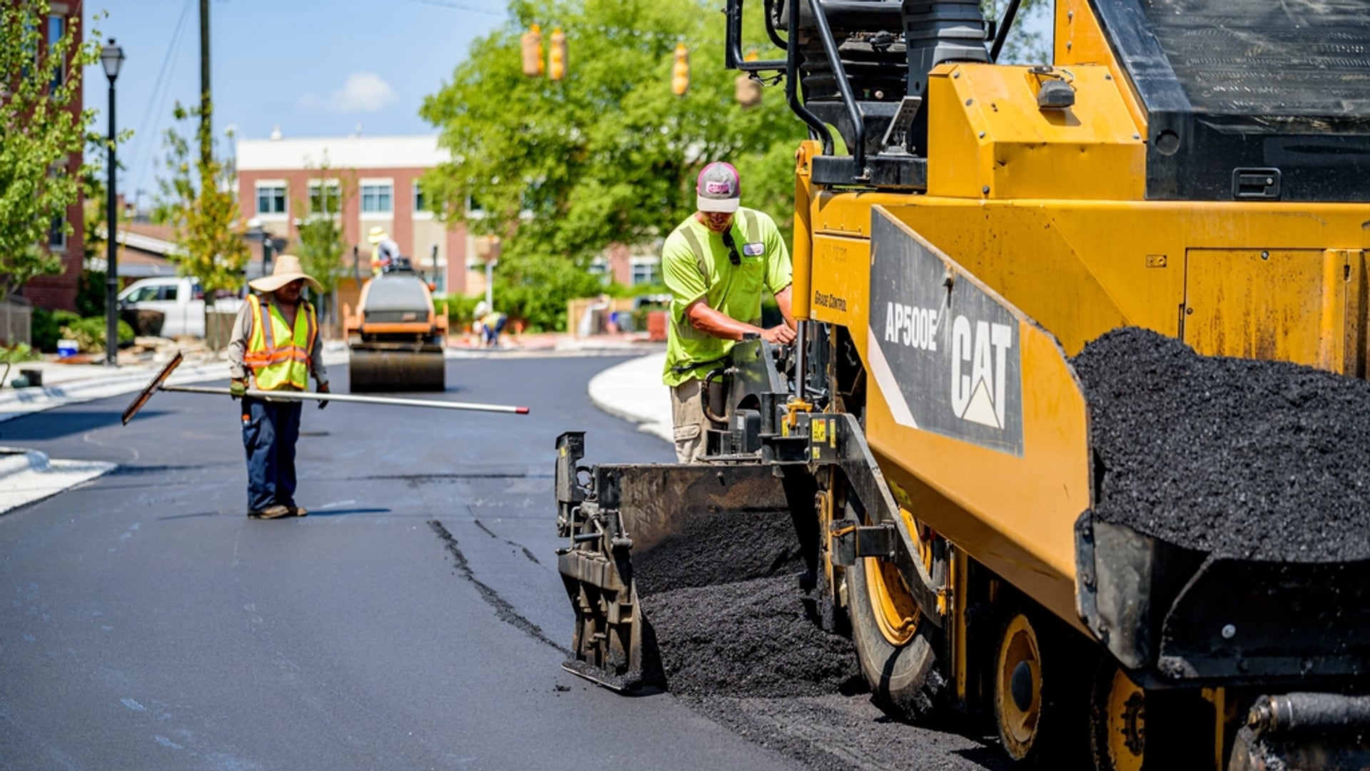 A Dewey Trail Contracting crew laying fresh asphalt in Mesa, AZ